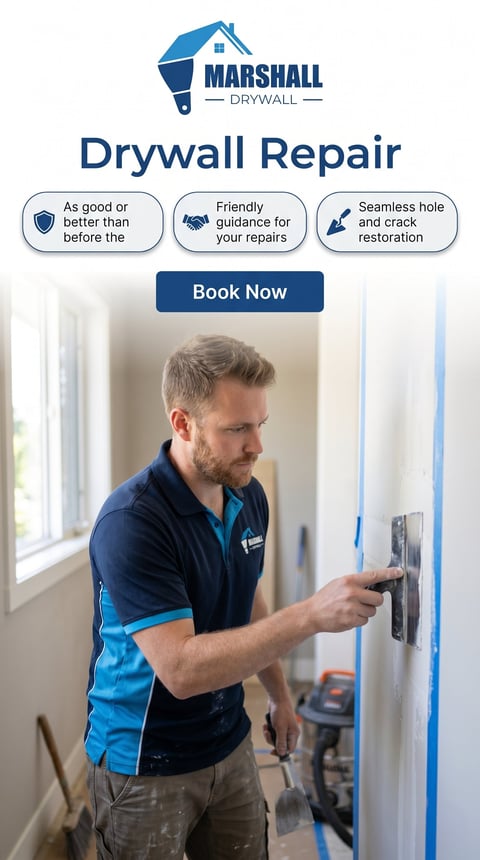 Marshall Drywall technician in blue uniform applying drywall compound with putty knife on interior wall