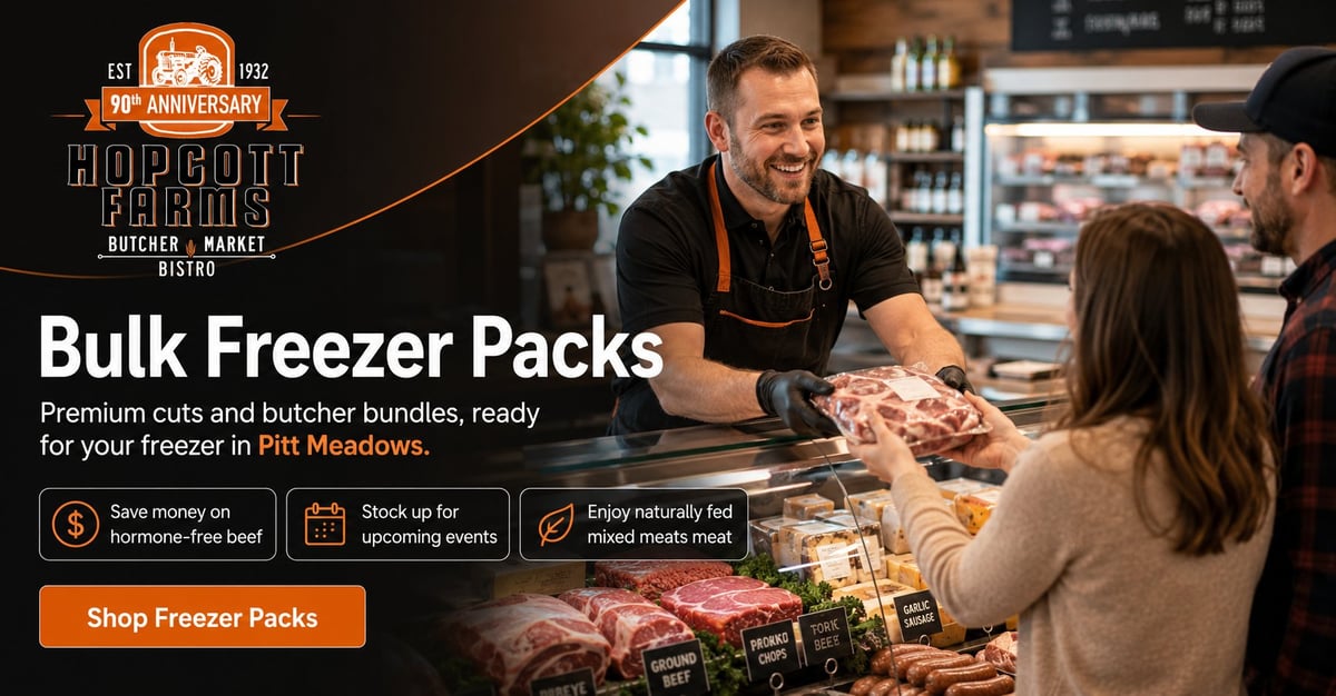 Butcher at Hopscotch market counter displaying bulk freezer packs of premium meat cuts to customers shopping for frozen provisions.