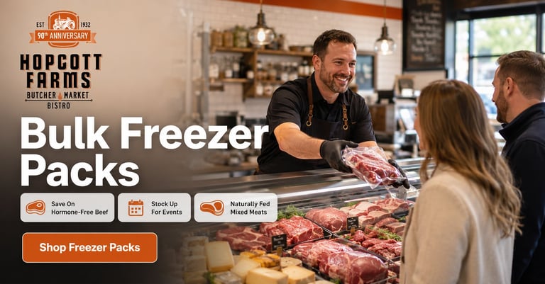 Hopcott Farms butcher shop employee serving customers at counter with raw meat display for bulk freezer packs